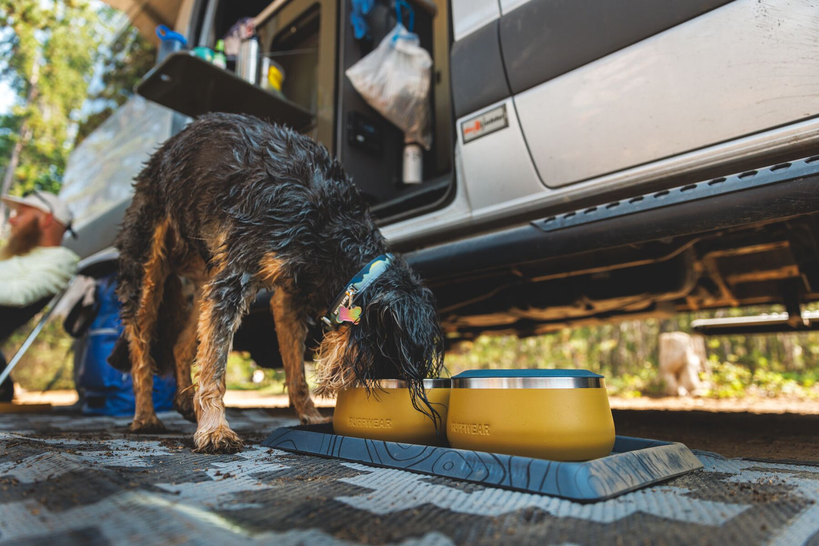 Dog eating from a Ruffwear Basecamp Bowl in Cattail Tan outdoors