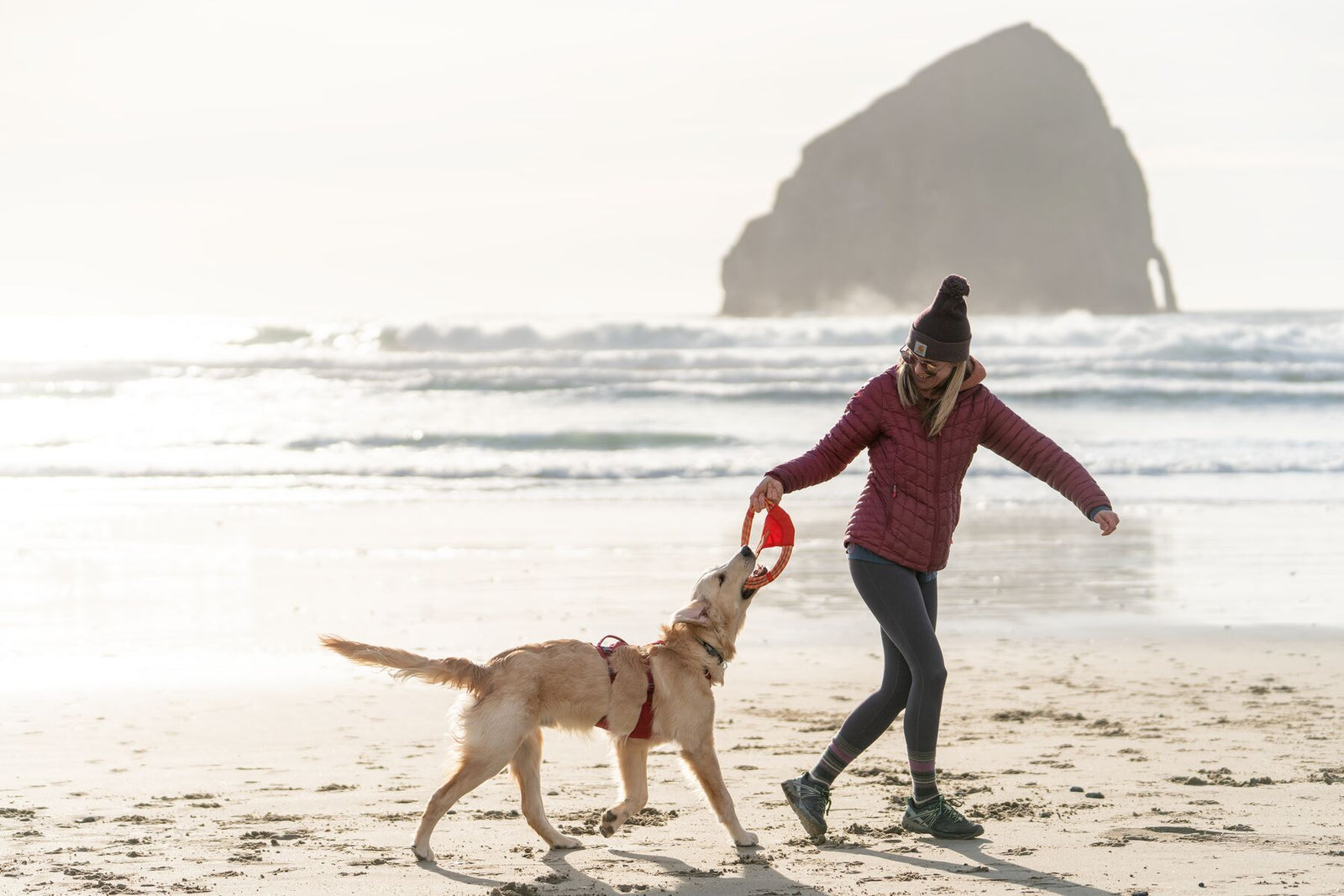 Ruffwear Pacific Ring toy in Sockeye Red - rope ring with red and gold ballistic nylon panels and Ruffwear badge, on white background