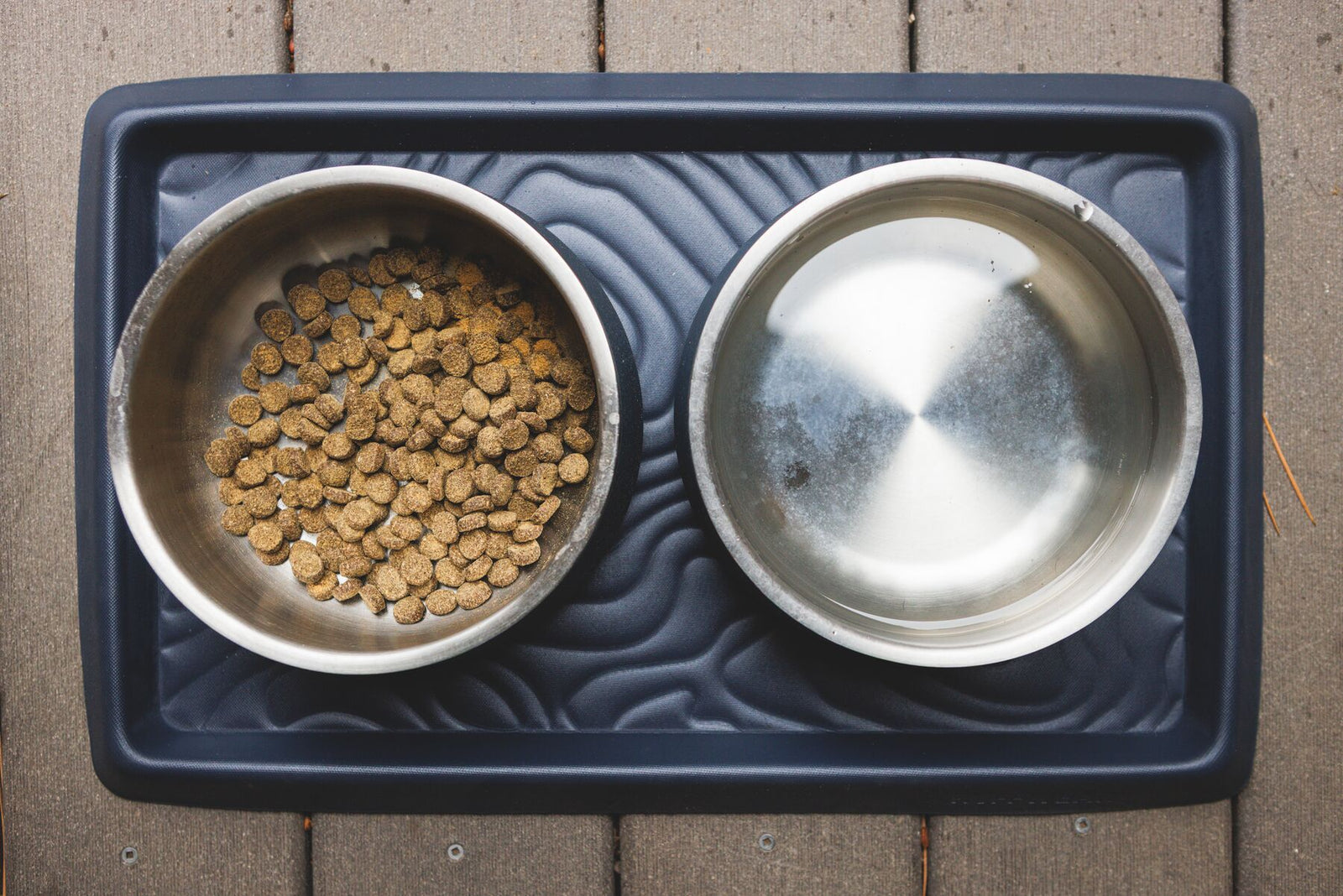 Two Ruffwear Basecamp Bowls with kibble on a Ruffwear Basecamp Mat