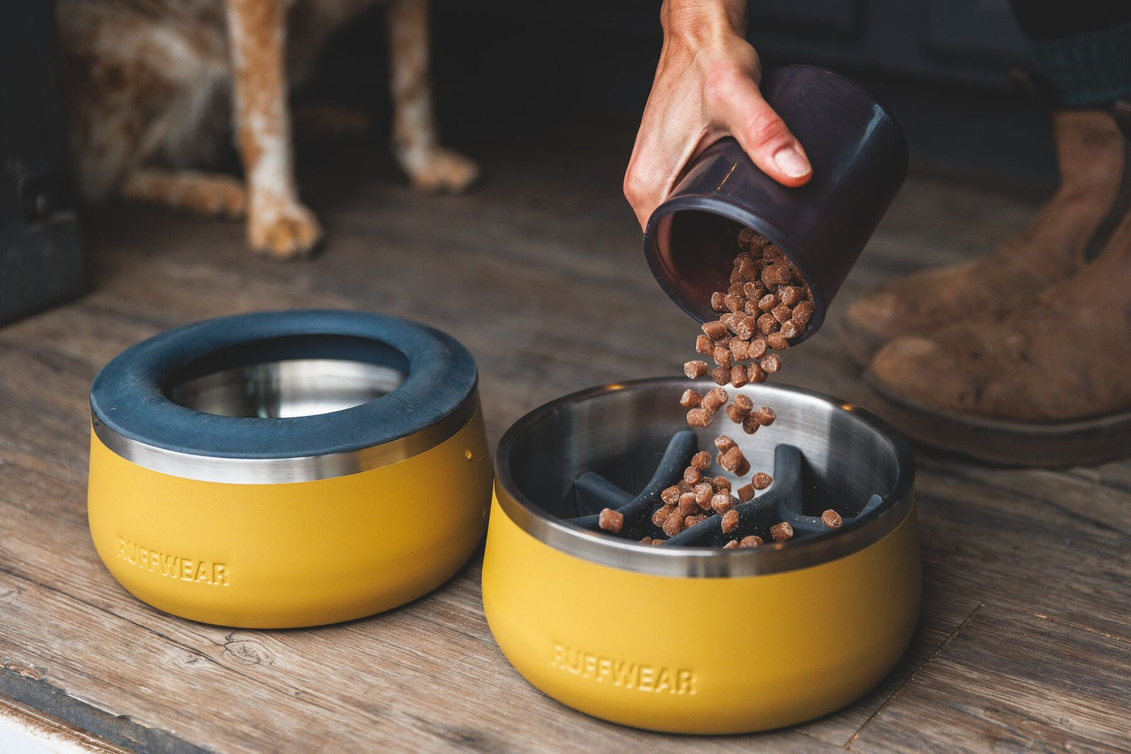 Person pouring kibble into a Ruffwear Basecamp Bowl in Cattail Tan